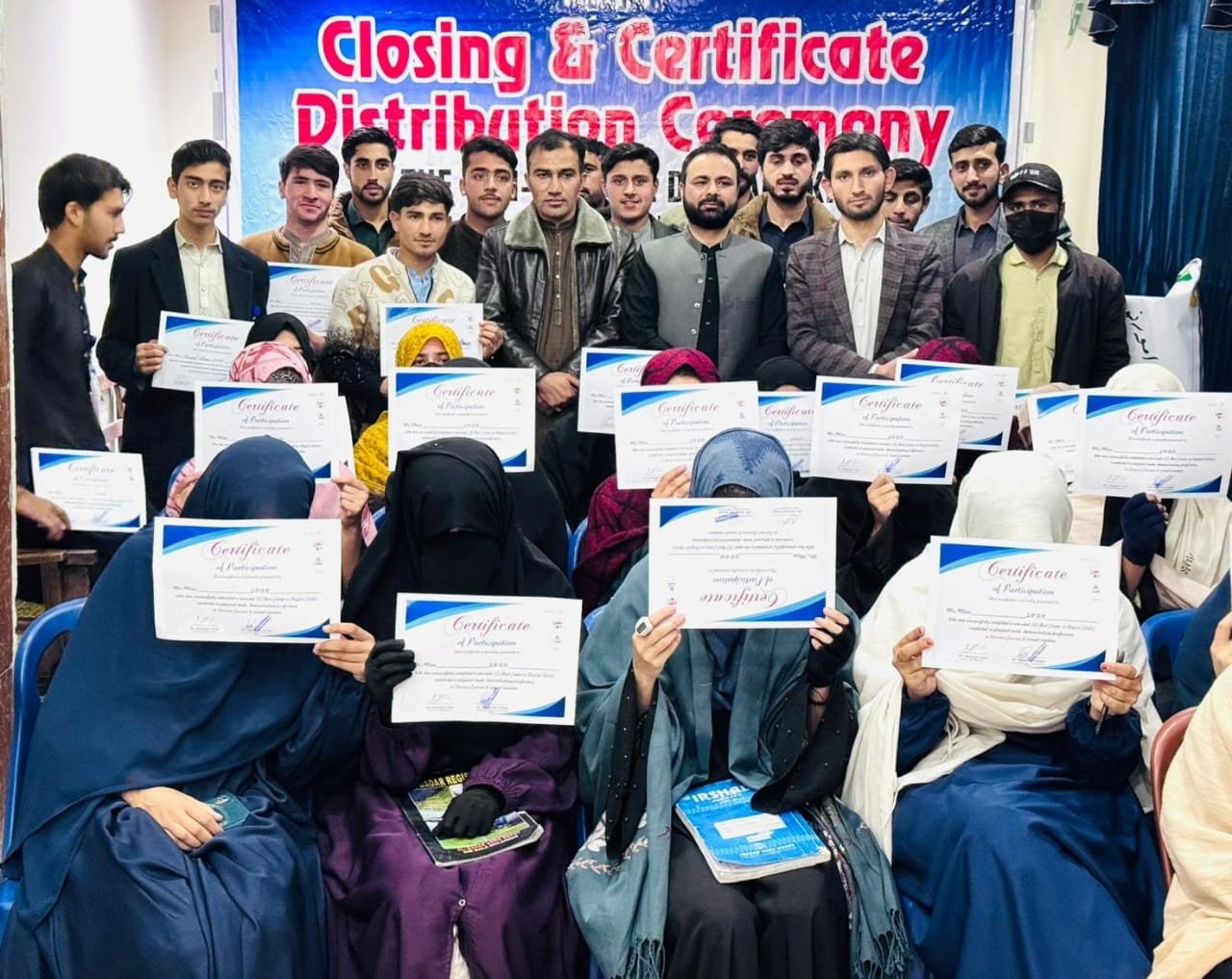 Group holding certificates at event.